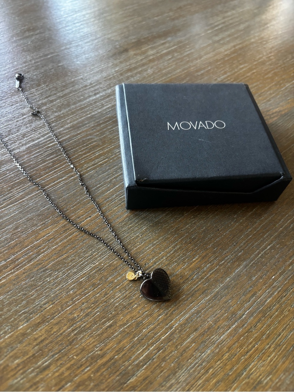 Movado Black Heart Pendant Necklace with Gold Accent Tag